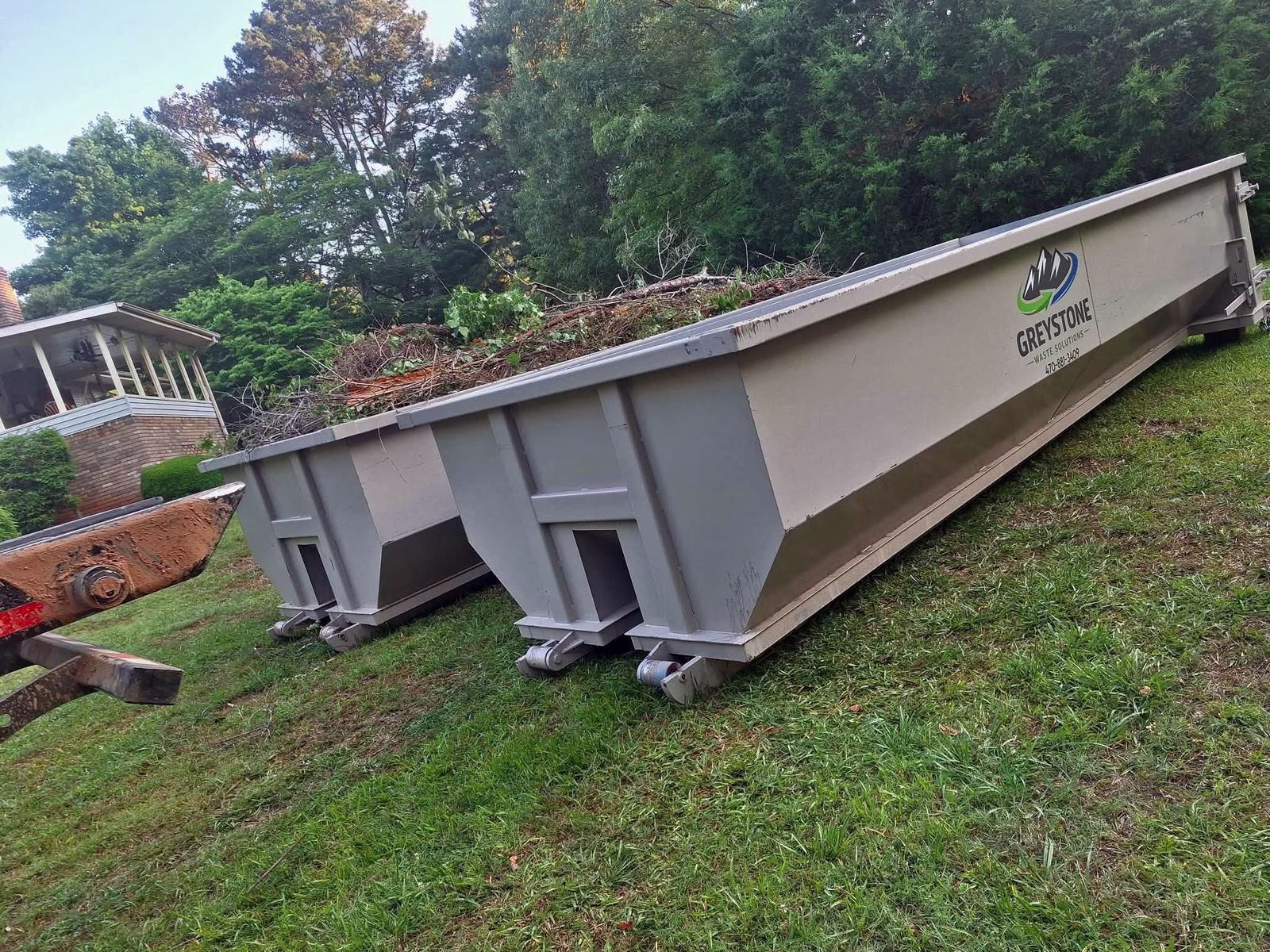 Greystone dumpsters staged at a residential property