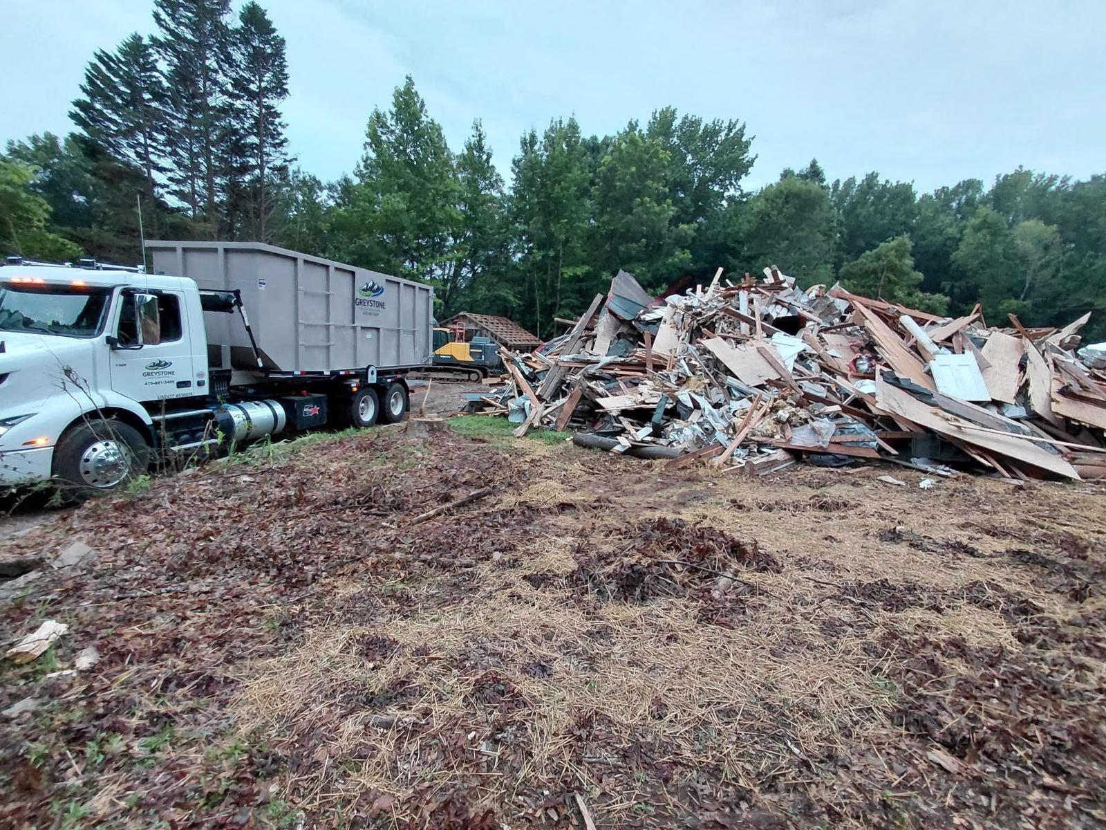 Greystone truck staged at a demolition site